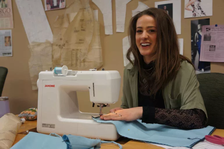 maggie barrett works a sewing machine in her class