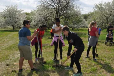 Photo of students planting trees in Fargo for Arbor Day
