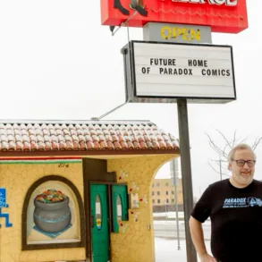 Photo of Paradox Comics-N-Cards owner Richard Early in front of new building