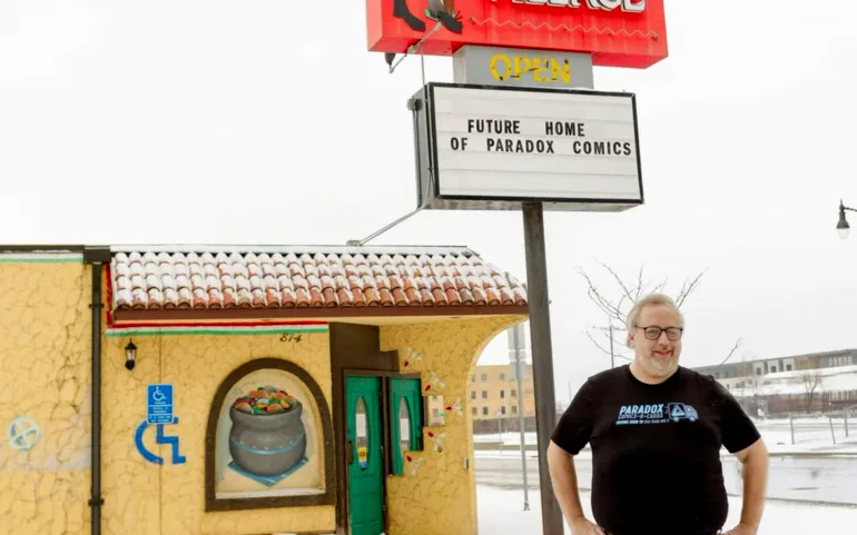 Photo of Paradox Comics-N-Cards owner Richard Early in front of new building