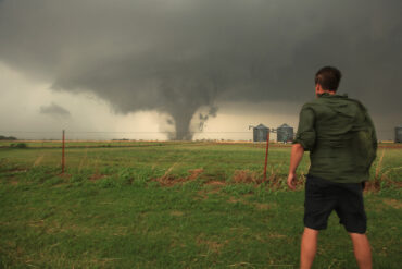 Photo of Dr. Reed Timmer looking at a tornado